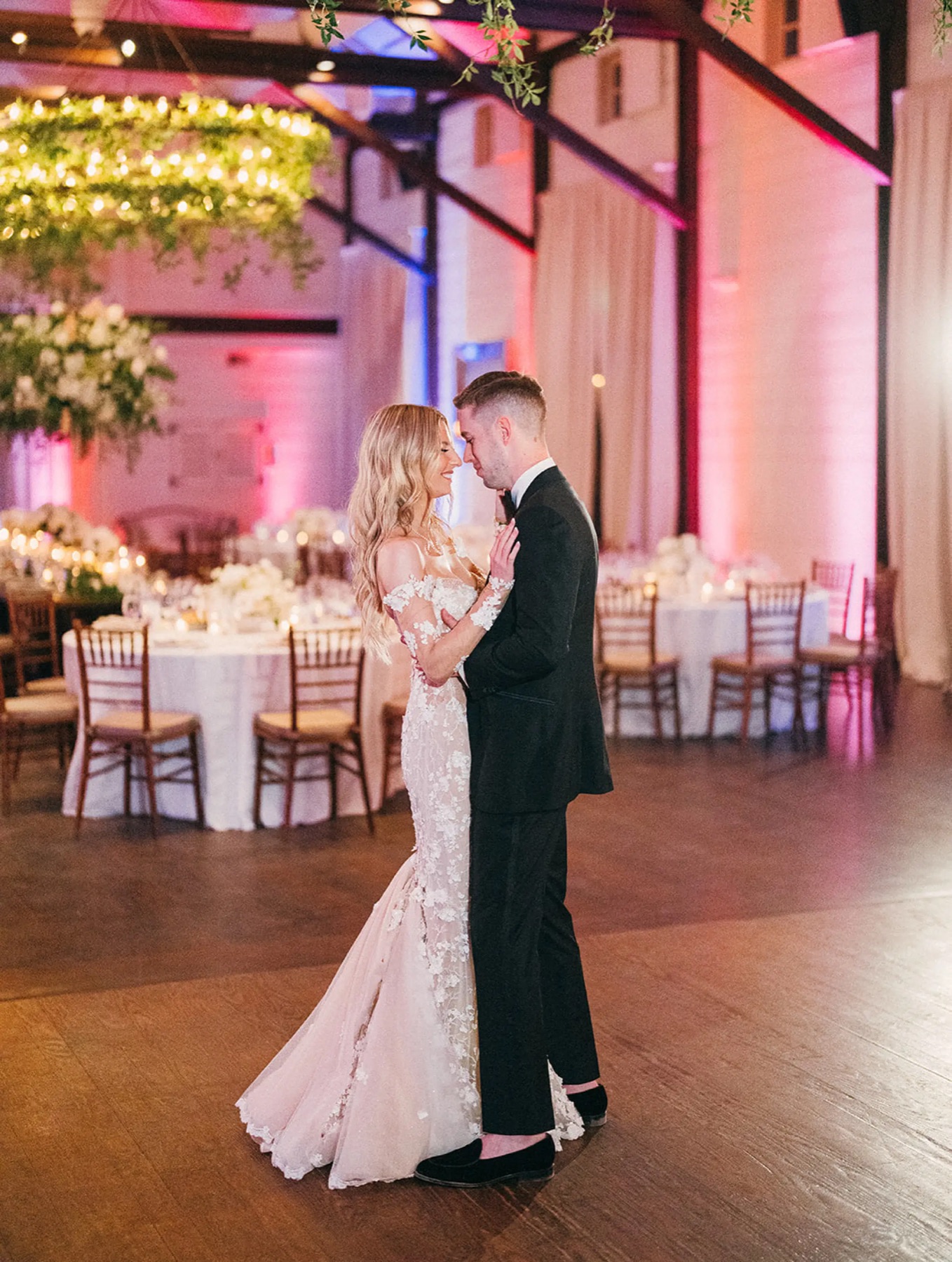 A first dance under pink uplighting